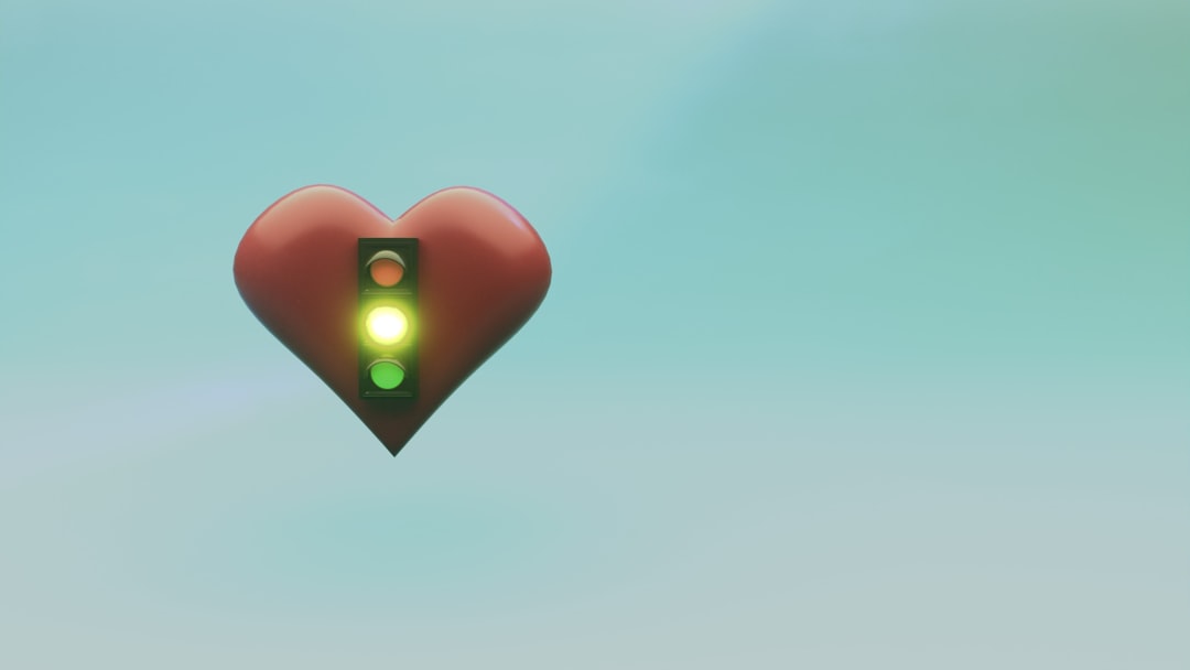 Red heart with green traffic light symbol against blue background
