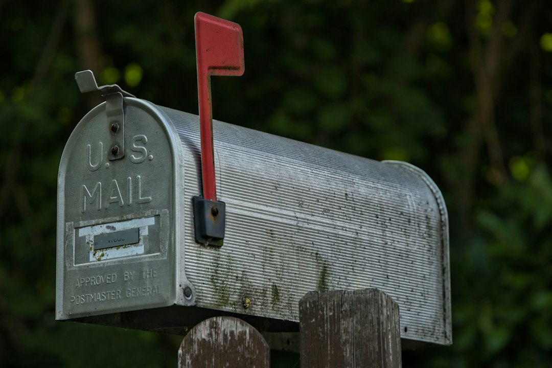 A weathered u.s. mailbox with a red flag