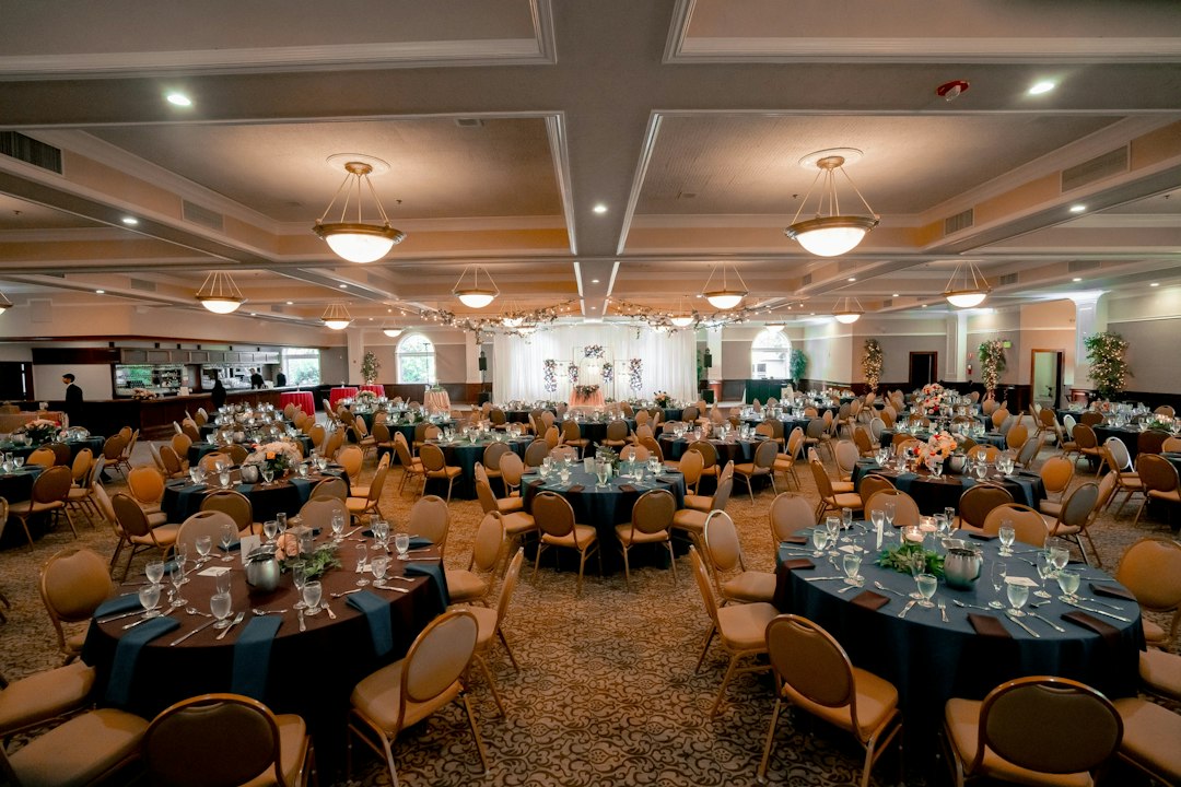 Elegant ballroom with numerous tables prepared for a formal event