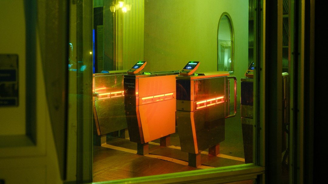 Entrance turnstiles illuminated with orange and green lights