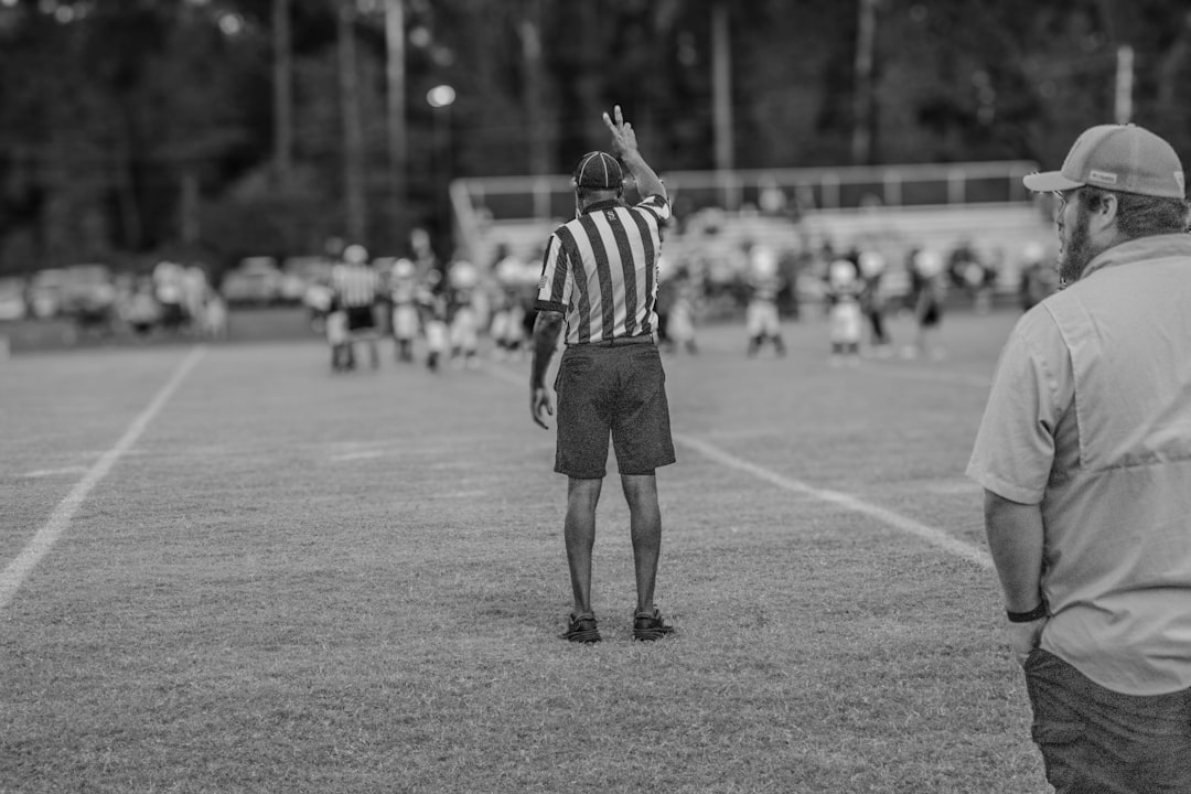 A black and white photo of a referee on a baseball field