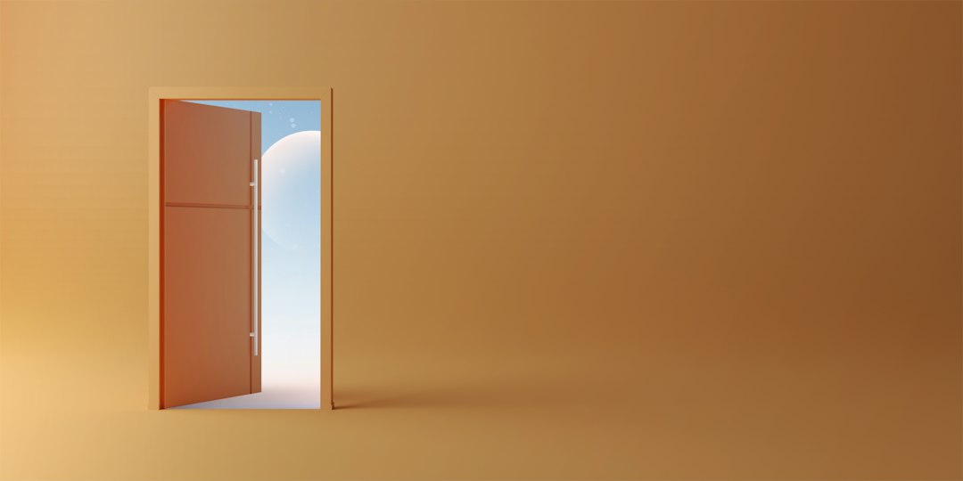 An open door revealing a bright blue sky with a white sphere