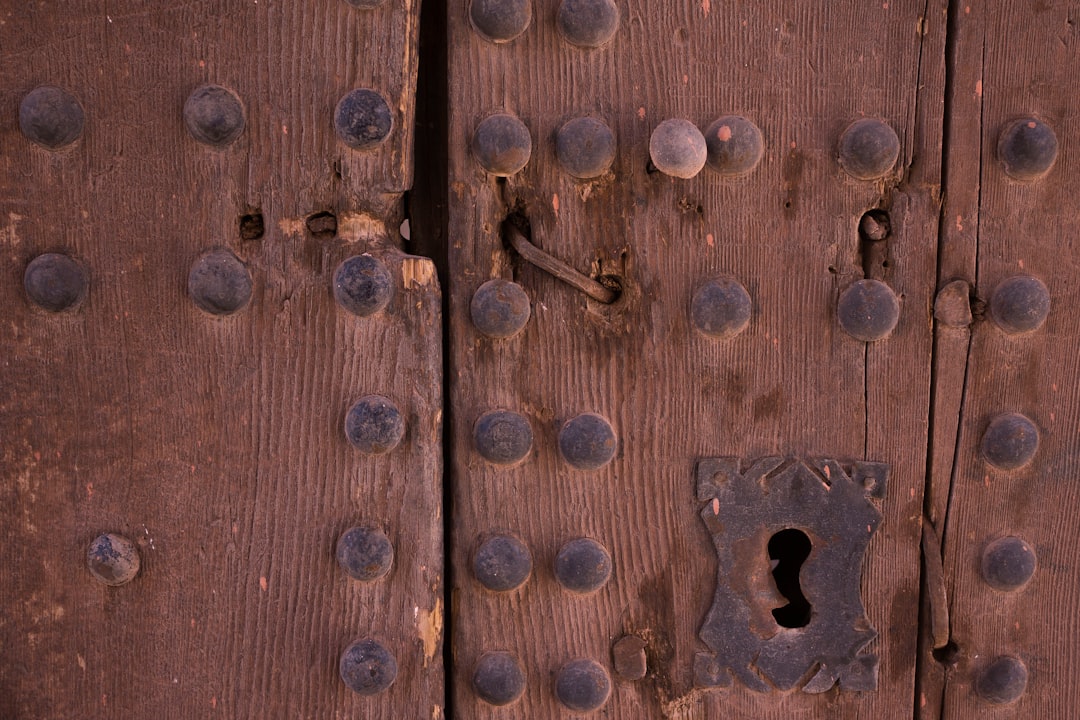 A close up of a wooden door with a keyhole