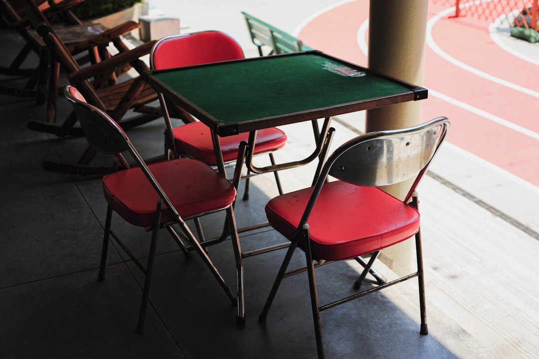 Red chairs and green table outdoors