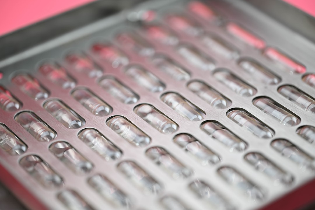 Rows of empty clear capsules in a tray