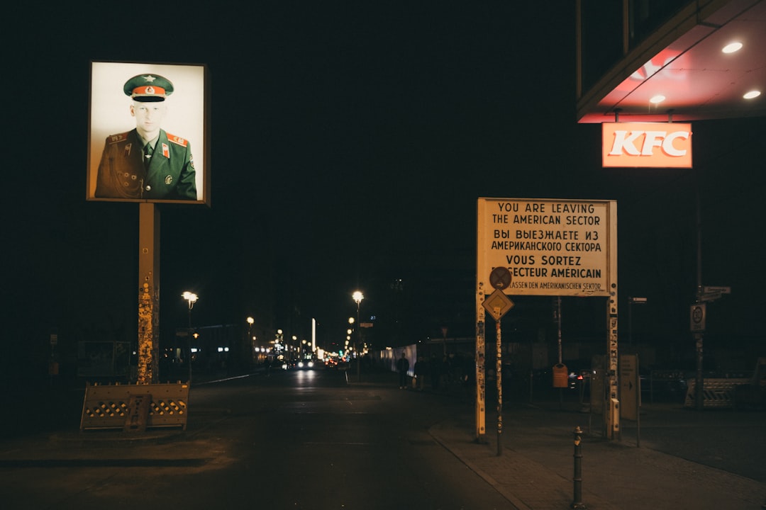 Portrait and kfc sign at night with street lights